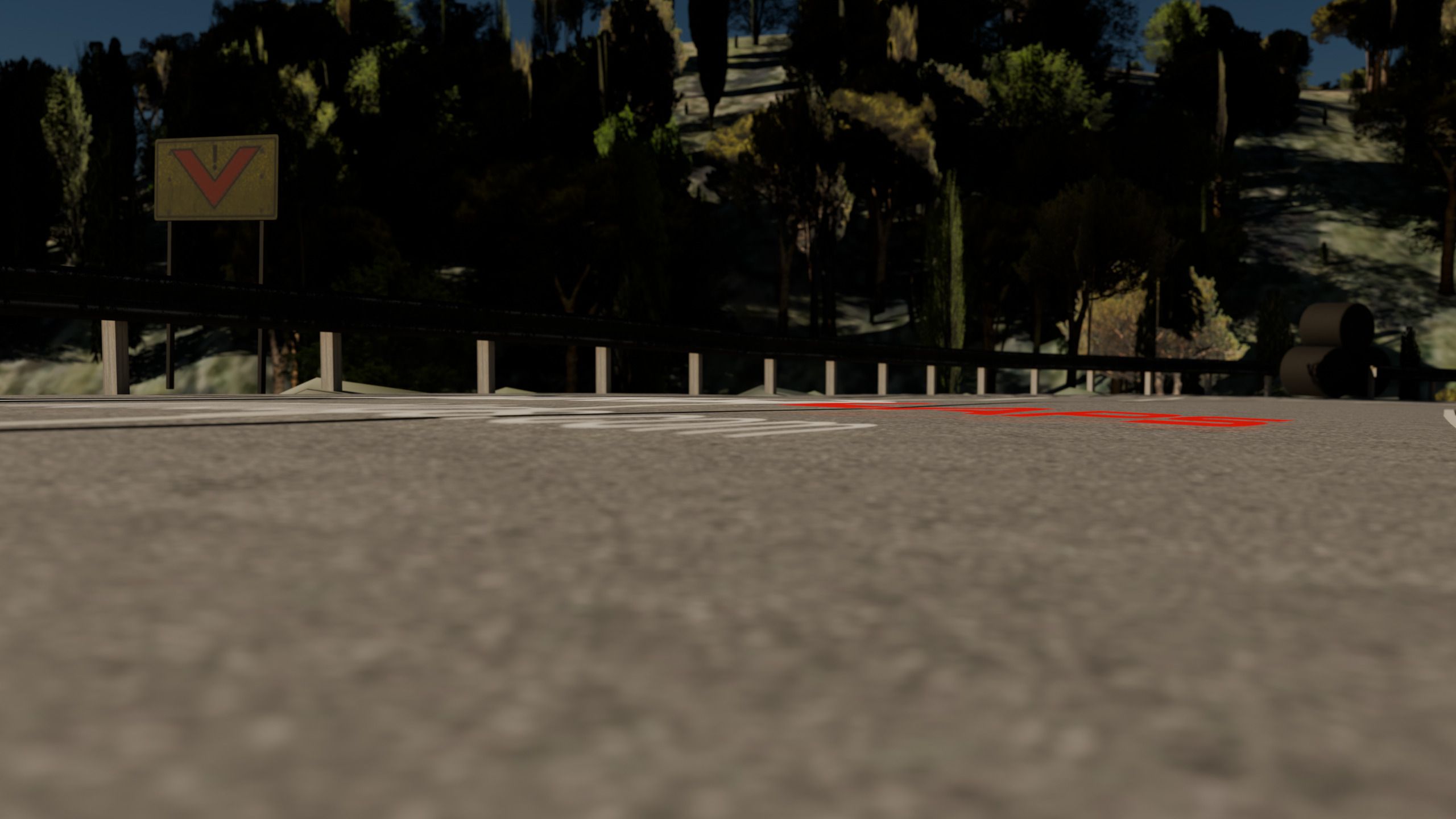 Primer plano rasante de la marca WORLDLAPS worldlaps.com pintada en el asfalto, con el grano de la carretera y la señal de preaviso al fondo.
