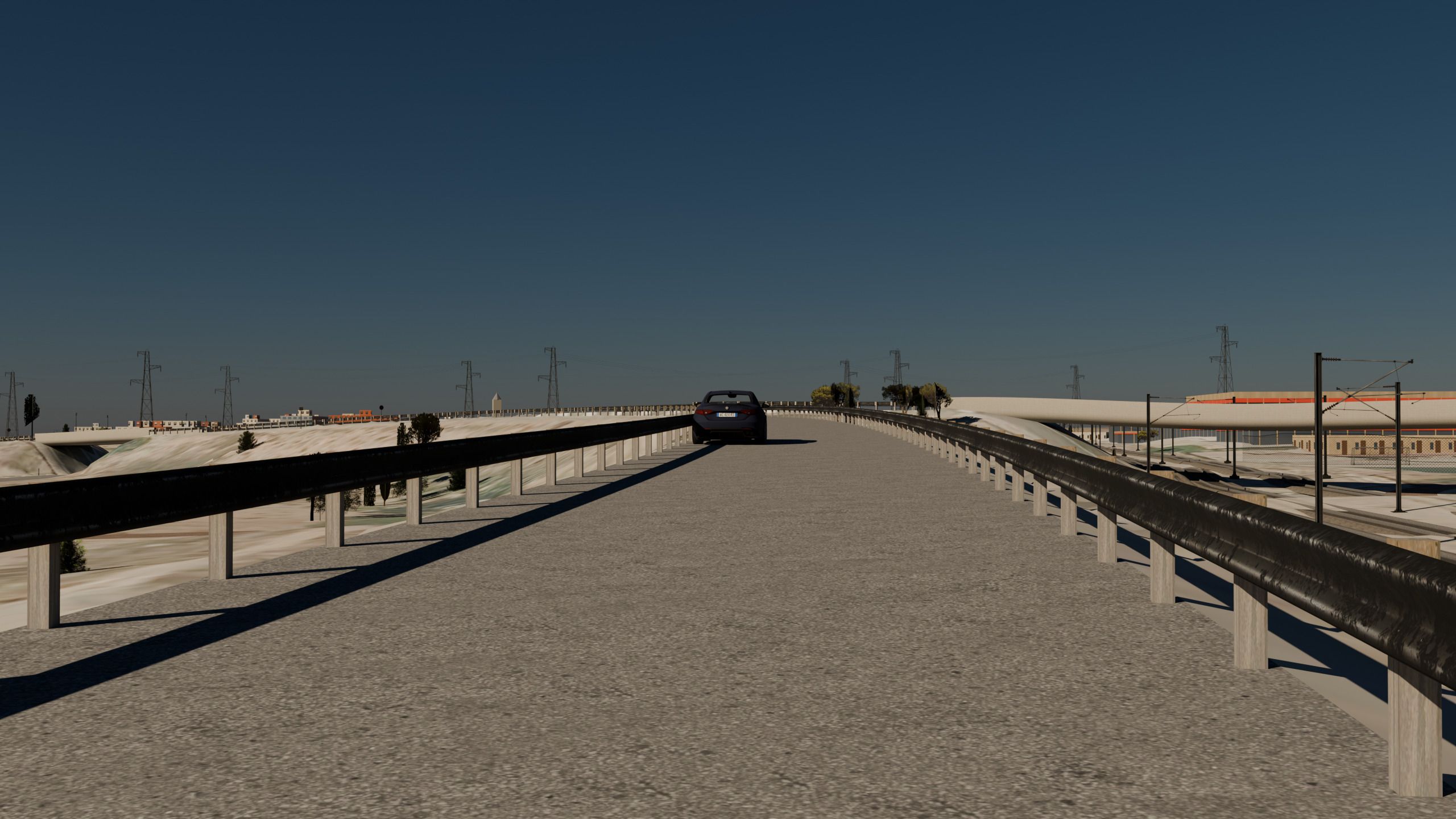 La calzada de la autopista sobre un viaducto, con el quitamiedos a ambos lados, un coche delante y las torres eléctricas al fondo.