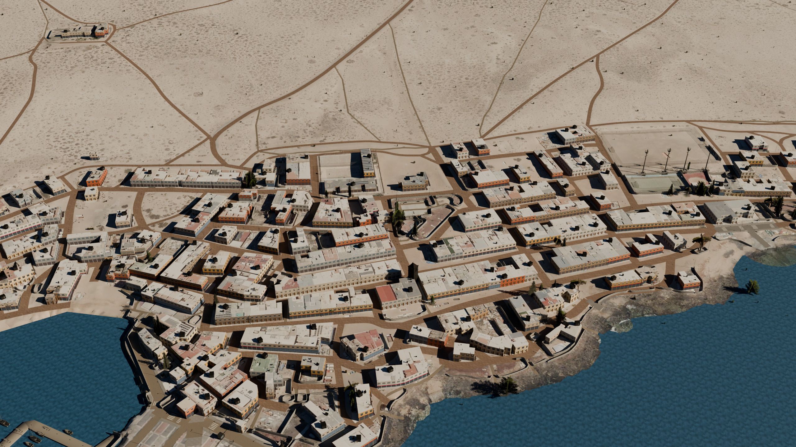 Vista aérea de Caleta de Sebo en La Graciosa: casas blancas bajas, calles de arena, el muelle y el mar.