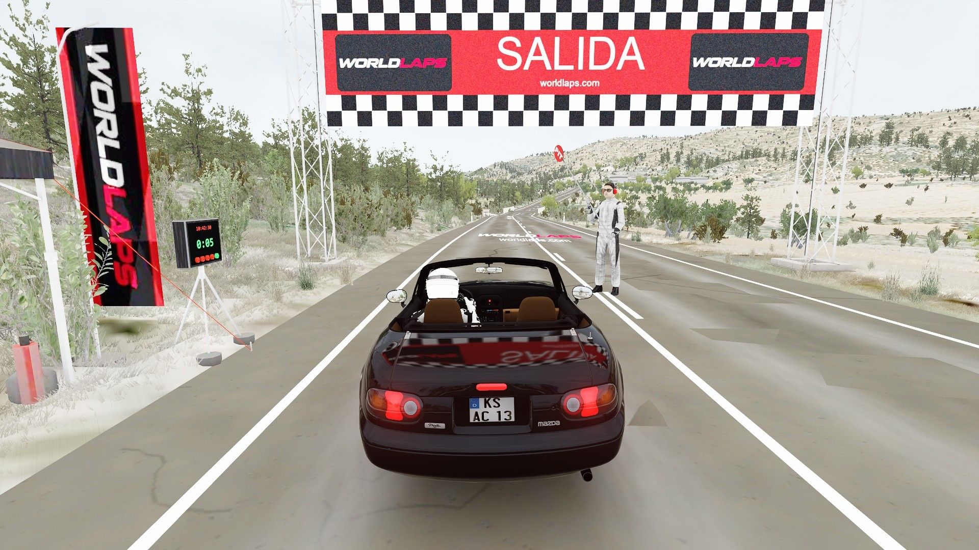 Assetto Corsa screenshot at the start of the Gestalgar stage: the car under the SALIDA gantry on a straight between pines and scrub.