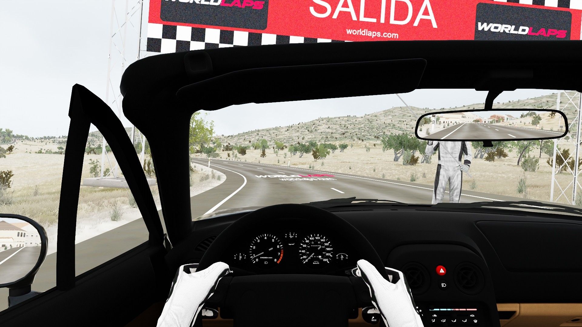 Driver's view at the start of the Los Herreros stage, with the start marshal and the SALIDA banner.