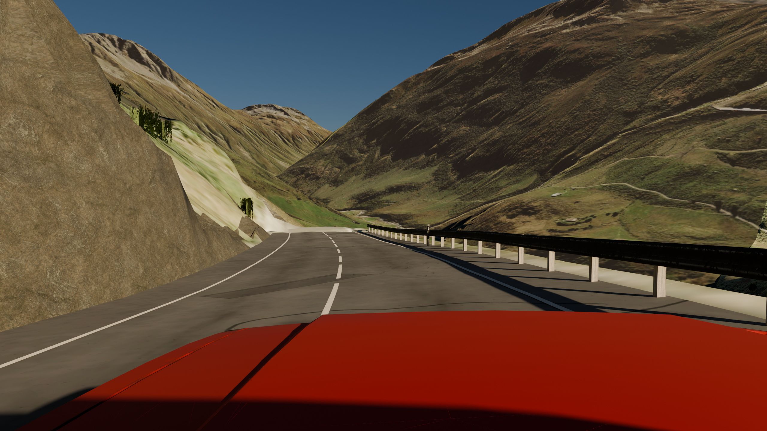 Vista desde el capó rojo del coche en la carretera del puerto del Oberalp, en Suiza, generada por Worldlaps: la carretera tuerce siguiendo el valle de Urseren entre laderas de pasto, con el quitamiedos a la derecha.