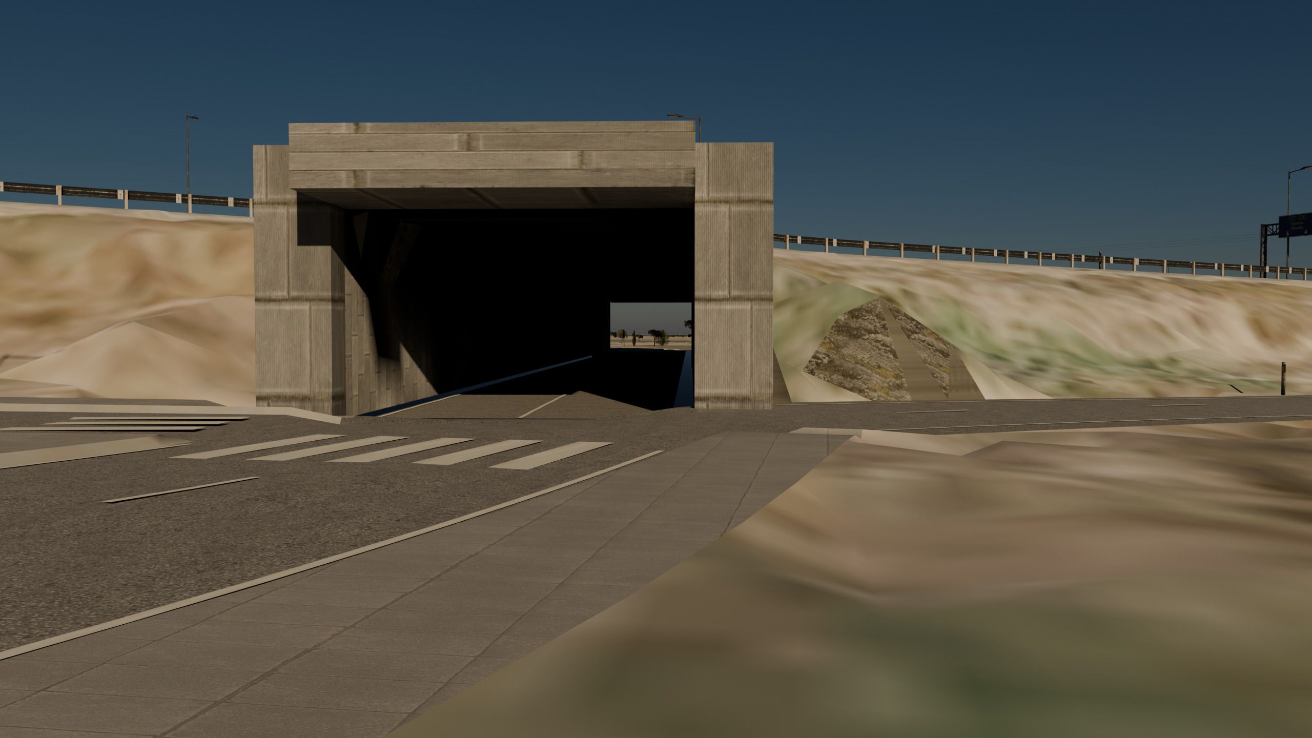 Boca de un paso inferior bajo la autopista: el portal de hormigón, la carretera que entra en la oscuridad y los quitamiedos de la autopista arriba.