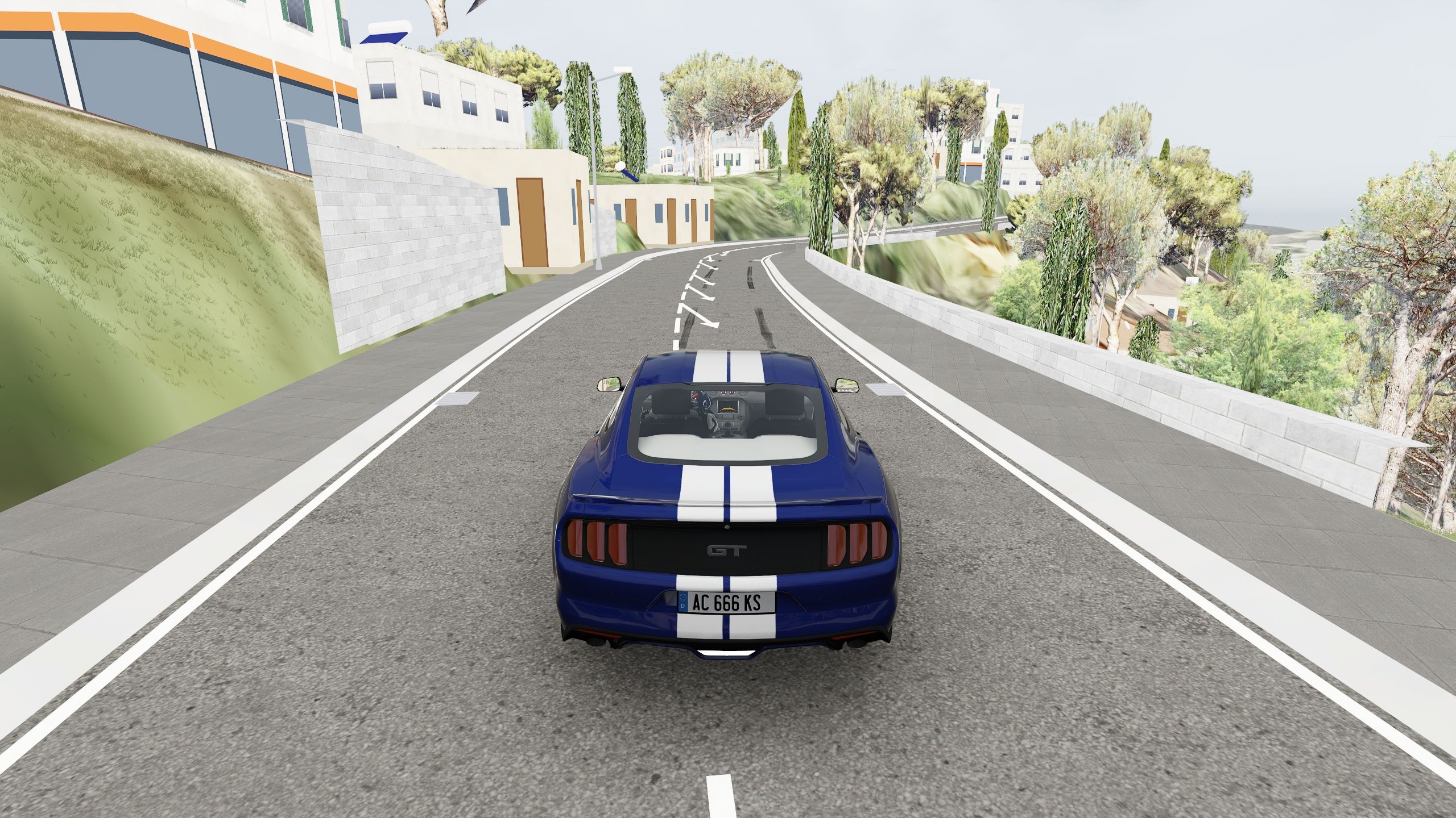 Unretouched Assetto Corsa screenshot at Serra: a retaining wall beside the road and a warning arrow before the bend.