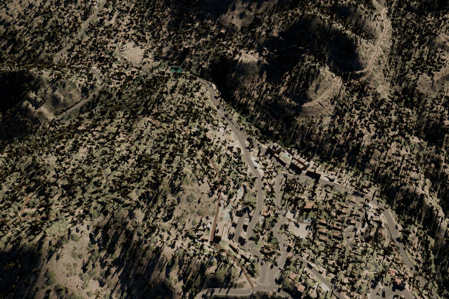 Vista aérea del pueblo de Serra entre pinares, con la carretera del Garbí subiendo por la sierra.